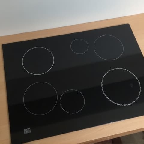 Before image of a heavily scratched electric cooktop surface in an Elk Grove home, showing significant wear and tear.