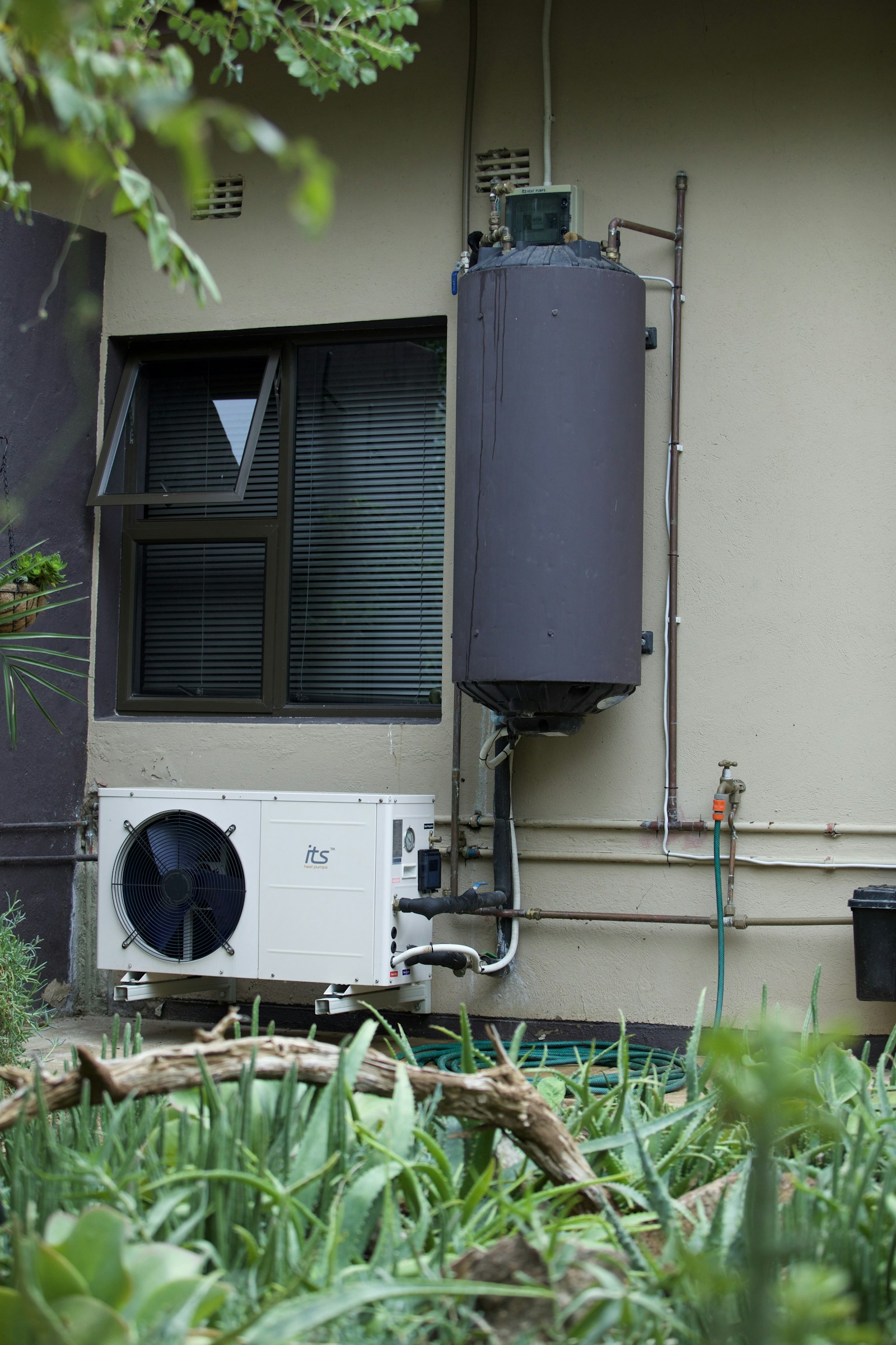 Real residential water-heater installation with visible piping.